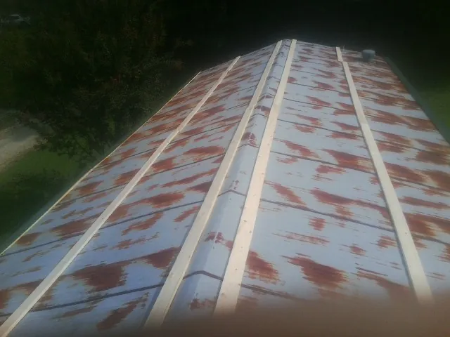 Rusted metal roof panels with new wood purlins before replacement — Storm Damage Roof Repair in Beaver by Roofing Brothers